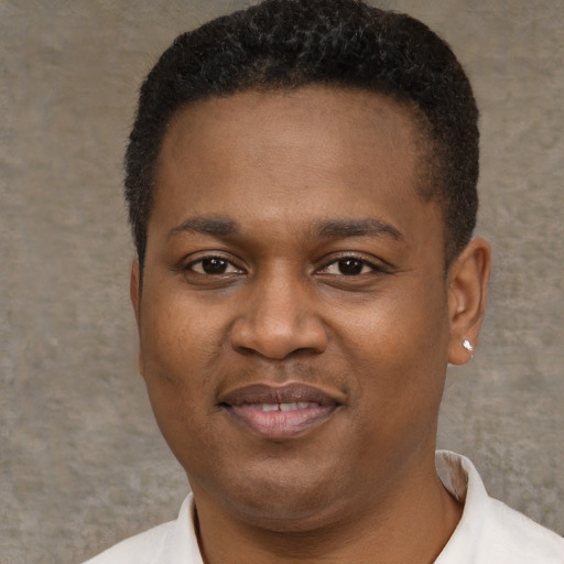 Joyful black young-adult male with short  brown hair and brown eyes