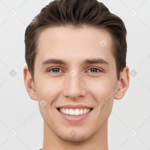 Joyful white young-adult male with short  brown hair and grey eyes