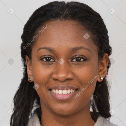 Joyful black young-adult female with long  brown hair and brown eyes