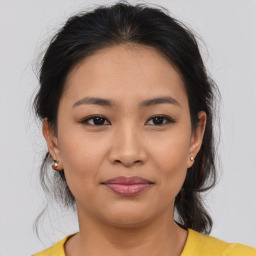 Joyful asian young-adult female with medium  brown hair and brown eyes