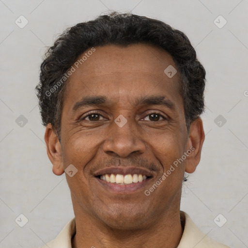 Joyful latino adult male with short  black hair and brown eyes