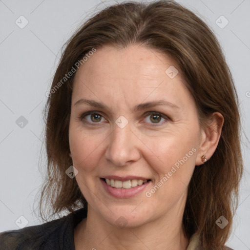 Joyful white adult female with medium  brown hair and grey eyes