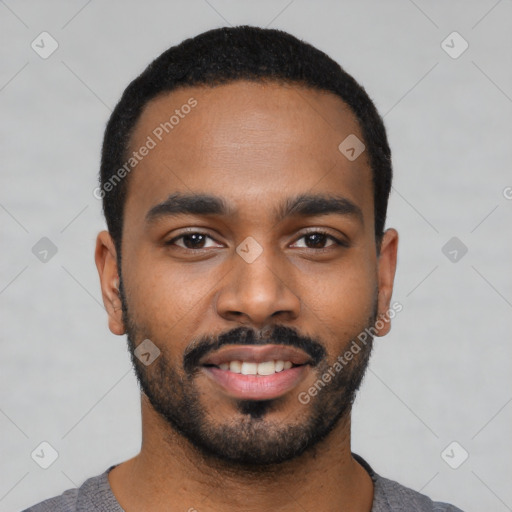 Joyful black young-adult male with short  black hair and brown eyes