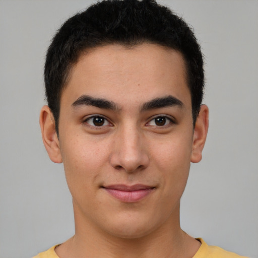 Joyful latino young-adult male with short  brown hair and brown eyes