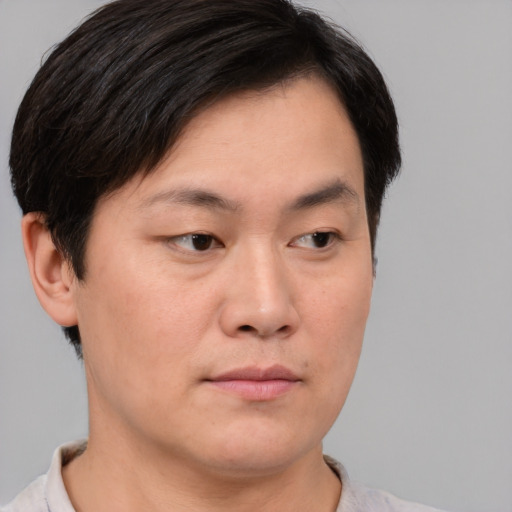 Neutral asian young-adult male with short  brown hair and brown eyes