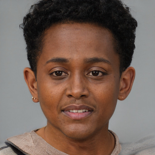Joyful black young-adult female with short  brown hair and brown eyes