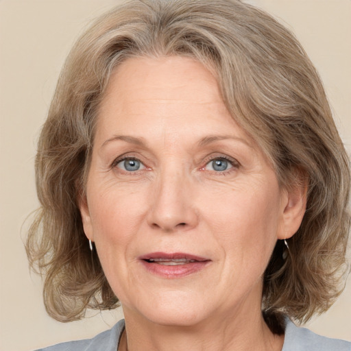 Joyful white middle-aged female with medium  brown hair and grey eyes