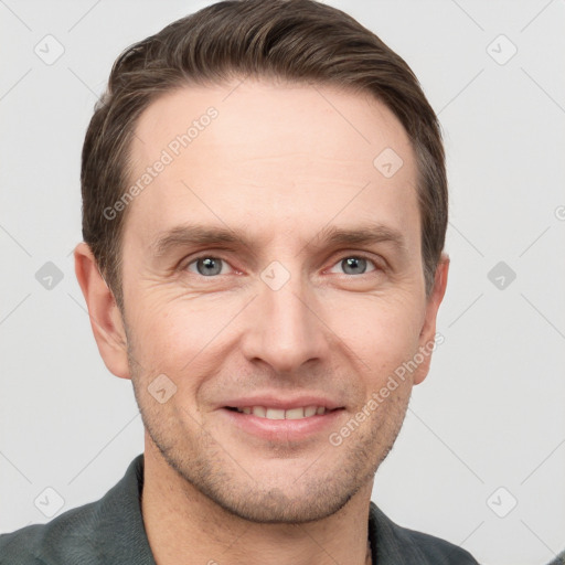 Joyful white adult male with short  brown hair and grey eyes