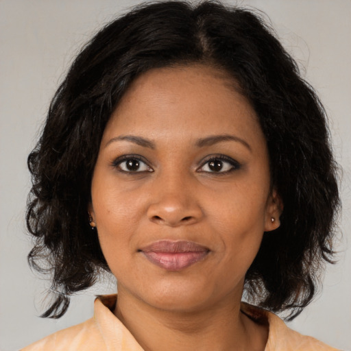 Joyful black young-adult female with medium  black hair and brown eyes