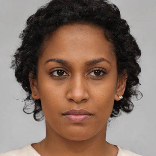 Neutral black young-adult female with medium  brown hair and brown eyes