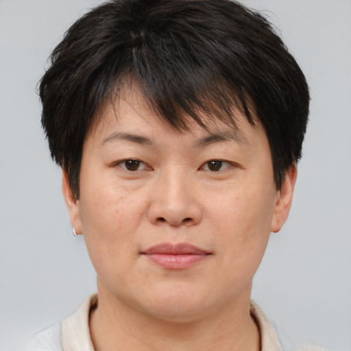 Joyful asian young-adult female with short  brown hair and brown eyes