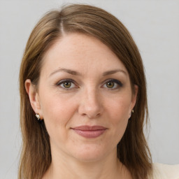 Joyful white young-adult female with medium  brown hair and green eyes