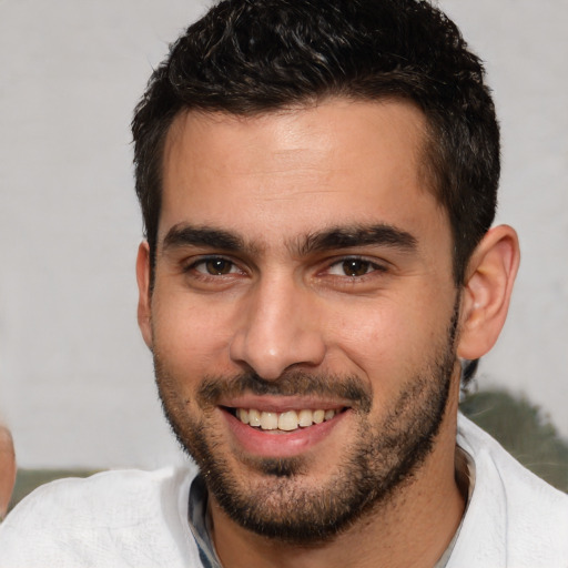 Joyful white young-adult male with short  brown hair and brown eyes