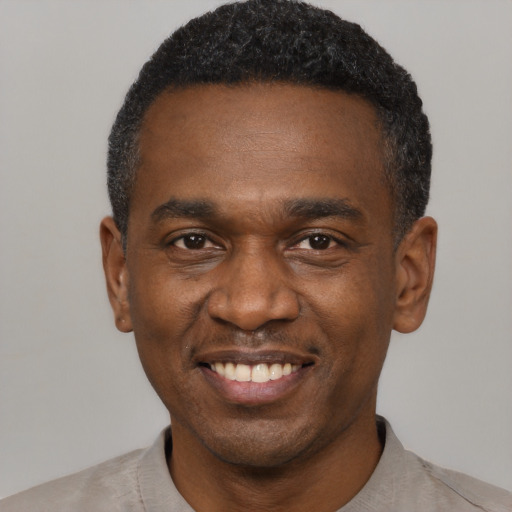 Joyful latino adult male with short  black hair and brown eyes
