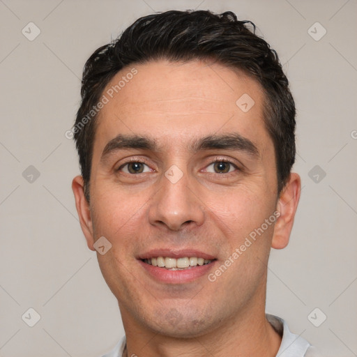 Joyful white adult male with short  black hair and brown eyes