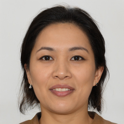Joyful asian young-adult female with medium  brown hair and brown eyes
