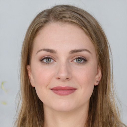 Joyful white young-adult female with long  brown hair and green eyes