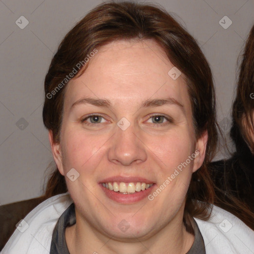 Joyful white adult female with medium  brown hair and blue eyes