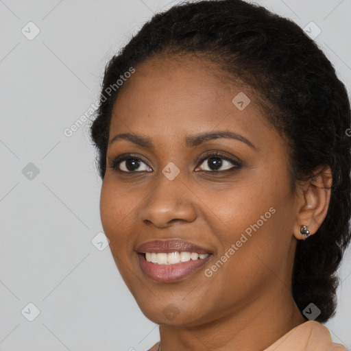 Joyful black young-adult female with long  black hair and brown eyes