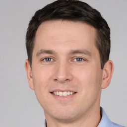 Joyful white young-adult male with short  brown hair and brown eyes