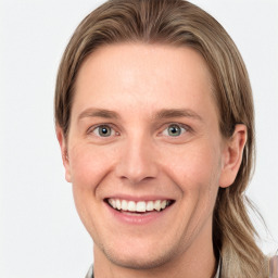 Joyful white young-adult female with long  brown hair and blue eyes