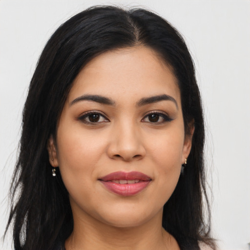 Joyful latino young-adult female with long  brown hair and brown eyes