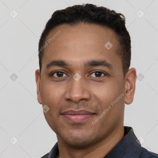 Joyful latino young-adult male with short  black hair and brown eyes