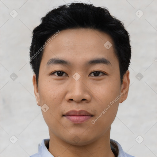 Joyful asian young-adult male with short  black hair and brown eyes