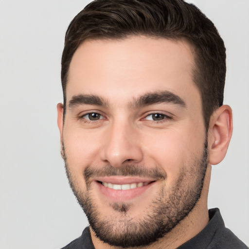 Joyful white young-adult male with short  brown hair and brown eyes