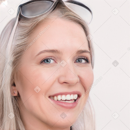 Joyful white young-adult female with long  brown hair and blue eyes