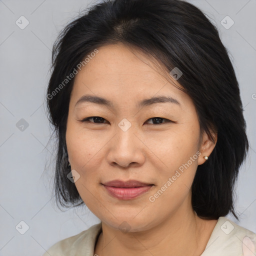 Joyful asian adult female with medium  brown hair and brown eyes