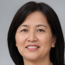 Joyful white adult female with long  brown hair and brown eyes