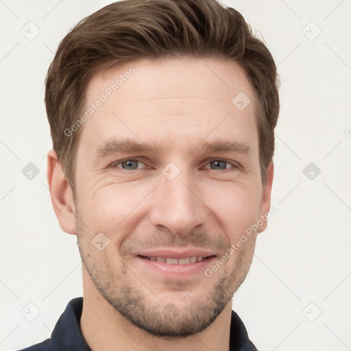 Joyful white young-adult male with short  brown hair and grey eyes