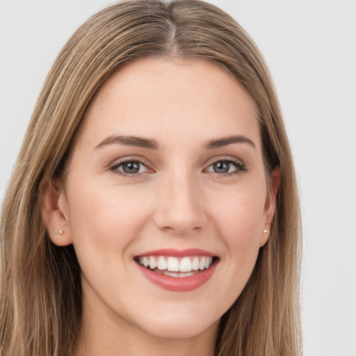 Joyful white young-adult female with long  brown hair and green eyes