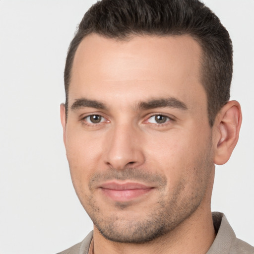 Joyful white young-adult male with short  brown hair and brown eyes