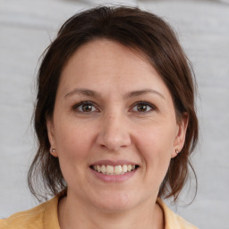 Joyful white young-adult female with medium  brown hair and brown eyes