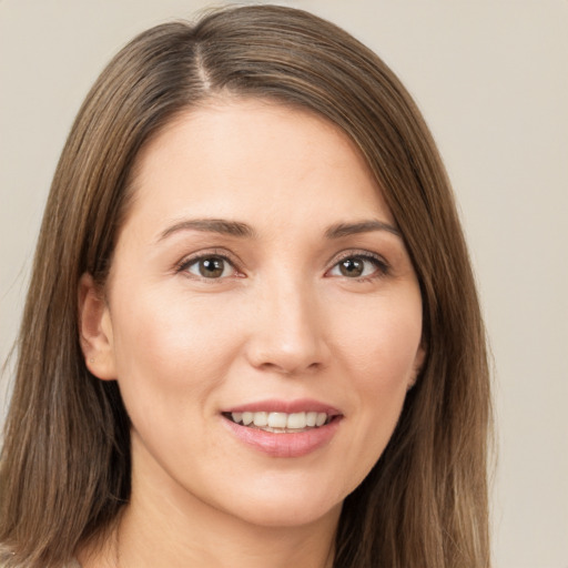 Joyful white young-adult female with long  brown hair and brown eyes