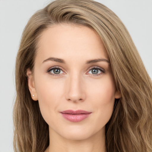 Joyful white young-adult female with long  brown hair and green eyes