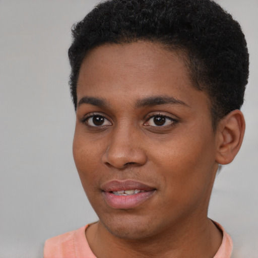Joyful black young-adult female with short  black hair and brown eyes