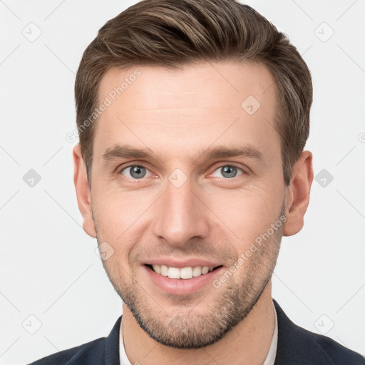 Joyful white young-adult male with short  brown hair and grey eyes