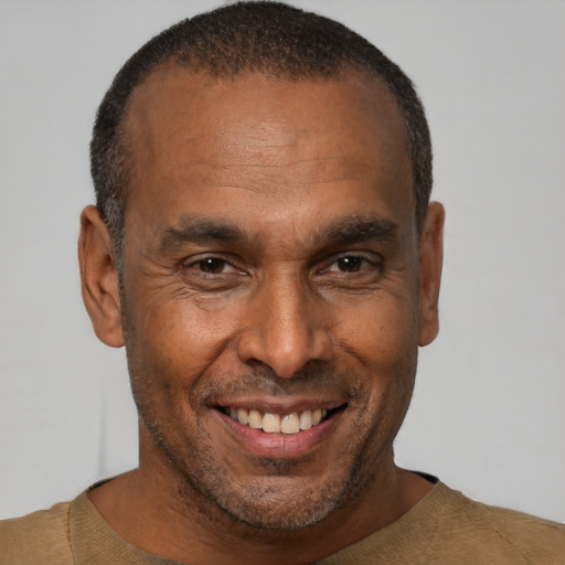 Joyful black adult male with short  brown hair and brown eyes