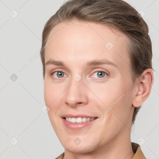 Joyful white young-adult female with short  brown hair and grey eyes