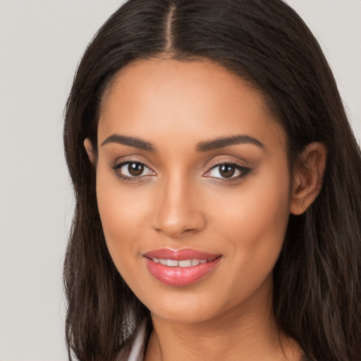 Joyful latino young-adult female with long  brown hair and brown eyes