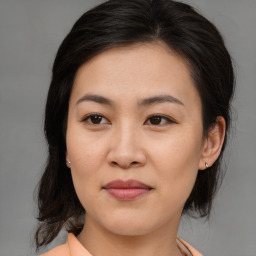 Joyful asian young-adult female with medium  brown hair and brown eyes