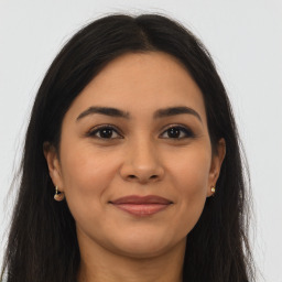 Joyful latino young-adult female with long  brown hair and brown eyes