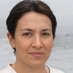 Joyful white adult female with short  brown hair and brown eyes