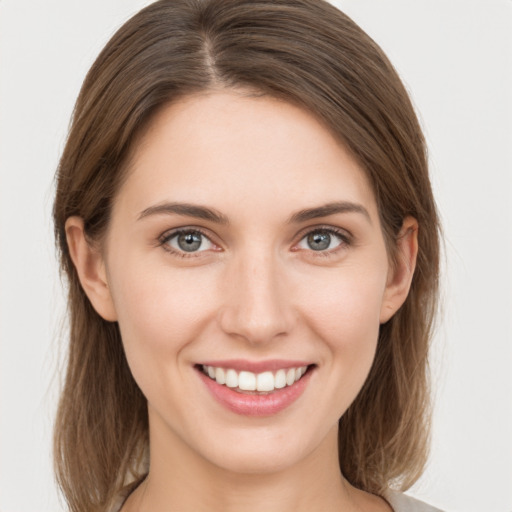 Joyful white young-adult female with medium  brown hair and grey eyes