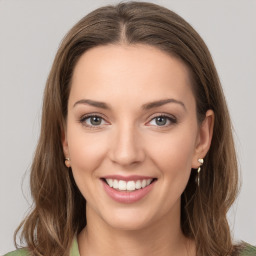 Joyful white young-adult female with long  brown hair and green eyes