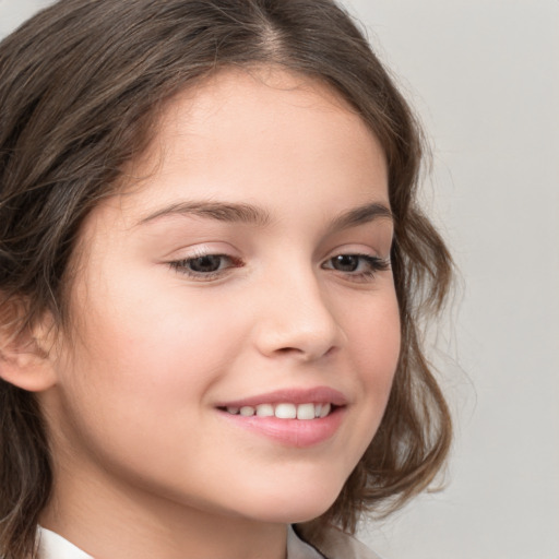 Joyful white child female with medium  brown hair and brown eyes