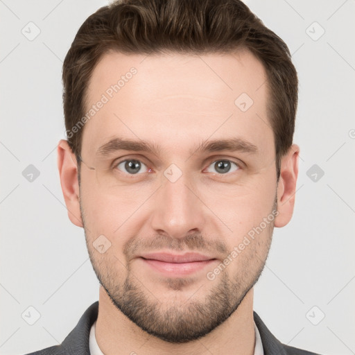 Joyful white young-adult male with short  brown hair and grey eyes